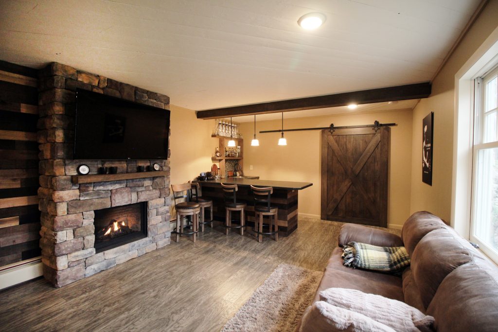 Renovated basement with fireplace and flat screen TV